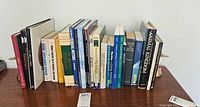 Side view of assorted nonfiction books spanning topics of sports, DIY, scholastic, cars, animals, and others, arranged upright with visible titles.