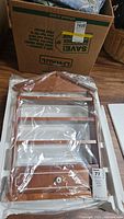 Wooden spice rack in original styrofoam packaging showing front view