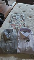 Three Pronto Uomo dress shirts including one nautical print and two solid colors in packaging
