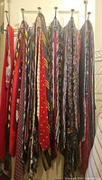 Neckties hanging on hooks showing a variety of colors and patterns
