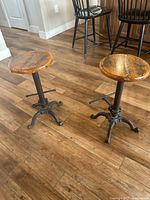Two stools on hardwood floor, showing overall appearance and style
