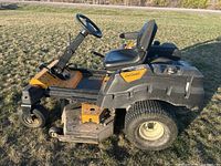Side profile view of yellow and black Cub Cadet zero turn mower on grass