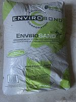 Single 25-pound bag of Envirobond Envirosand showing brand, product type, and color granite designation with weight in lbs and kg.