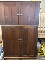 Full front view of two-piece cabinet with upper and lower paneled doors