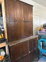 Full view of two-part cabinet showing upper and lower sections in storage area