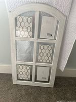 Photo of farmhouse style rustic white picture frame with 6 5x7 picture sections, showing wood texture and glass panels.