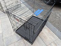 Full view of the foldable metal wire pet crate showing the structure, door, and plastic base tray