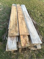 Top view of stacked rough sawn pine boards showing varying widths and lengths