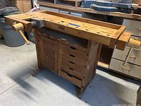 Full view of the workbench showing top, storage and vices