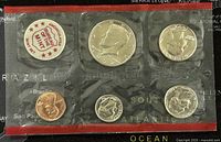 Front side of the 1972 US Mint Proof-Like Six Coin Set in sealed packaging showing penny, nickel, dime on bottom row and quarter, half dollar, dollar on top row.