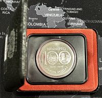Oblique view of the 1974 Canadian silver dollar coin in black presentation case with red lining showing Winnipeg Centennial design.