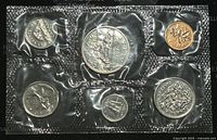 Front image showing six coins in sealed plastic packaging, arranged in two rows of three, with each coin visible and distinct under a protective cover.