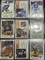 Nine 1981-82 O-Pee-Chee NHL trading cards laid flat in a nine-pocket binder sleeve, showing front and back of cards with player images and team logos visible.