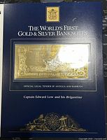 Front view of the limited edition banknote in the dark blue backing card showing title and official designation as legal tender.
