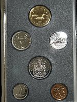 Six Canadian coins in specimen condition arranged in a plastic case with foam backing, showing both obverse and reverse sides featuring Queen Elizabeth II and Canadian symbols.