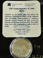 Close-up of the information card describing the coin's composition, size, and design origin.