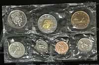 Front and back view of 7 Canadian coins from 1999 in sealed plastic packaging showing proof-like condition.