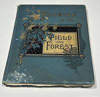 Front cover of antique hardcover book with floral design and title