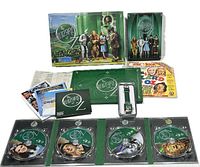 The full contents of The Wizard of Oz 70th Anniversary Collector's Box set layout including DVDs, books, wristwatch, and box.