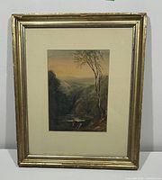 Full view of the antique framed watercolour painting showing the landscape scene and aged gold frame with visible wear.