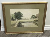 Framed and matted landscape watercolour painting showing the entire frame and mat.