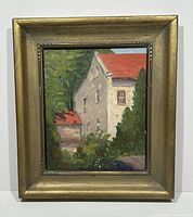 Framed painting showing the entire artwork including the gold frame, depicting a European estate building with red roof and surrounding trees.