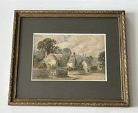 Front view of framed watercolour painting showing full frame, mat and artwork depicting cottage scene
