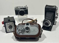 Overview of four cameras: Movikon 8 with case, Imperial box camera, Konica C35, Zeiss Ikon folding camera