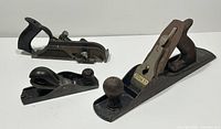 Photo showing all three vintage Stanley hand planes together: Stanley Bailey No 5 smoothing plane, Stanley No 78 shoulder plane, and Stanley No 110 jack plane, depicting their size differences and condition.