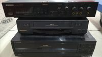 Front stacked view of Pioneer MA-9 MIC Mixer, Daewoo VHS-HQ VCR, and Pioneer CLD-980 LaserDisc Player