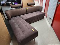 L-shaped sectional sofa with two adjustable headrests, tufted cushions, metal legs