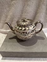 Sadler ceramic tea pot with silver and white floral pattern, shown from the side with handle and spout visible.