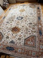 Full view of rug on hardwood floor showing overall pattern and size