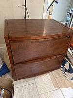 Full view of the wooden 2 drawer lateral filing cabinet, showing its brown finish and drawer design.