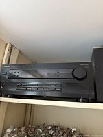 Front view of the black Pioneer audio-video receiver with multiple buttons and a large volume knob.