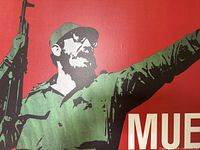 Close-up of military figure with rifle and extended arm on red background