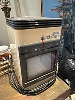 Front angle view showing Sony Mega Watchman with screen, tuner markings for FM, AM, VHF, UHF, and channel numbers. Visible red mark on unit.