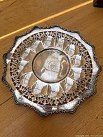 Overall top view of pierced sterling silver dish showing scalloped border and central well.