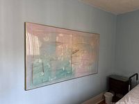 Framed abstract mixed media artwork on paper hanging on wall