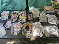 Group shot of all 14 aluminum cake pans on table