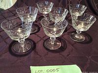 All seven crystal dessert dishes on tablecloth