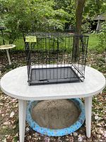 Closed view of black wire dog crate on table