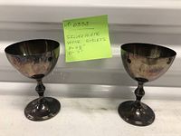 Front view of two silver-plated goblets showing overall form and tarnish