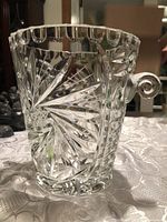 Front view of cut crystal ice bucket showing pinwheel pattern and handle