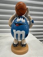 Front view of Blue M&M basketball candy dispenser