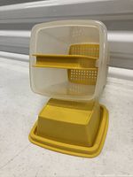 Container assembled with strainer shown in position