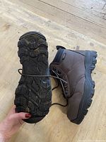 Sole of one boot showing tread pattern and condition, no wear visible.