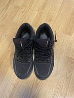 Top view of men's FILA black running shoes showing overall condition and lace-up design.