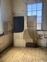 Canvas artwork placed against a wall with window light showing the abstract geometric shapes in neutral tones.