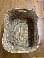 Rectangular woven basket viewed from top showing interior and handle slot.